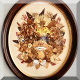 A13. Dried flower arrangement in oval frame.